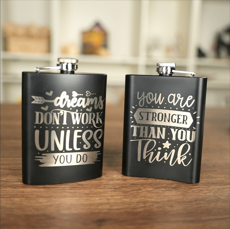 Personalized black stainless steel water bottles featuring custom inspirational quotes, marked with the Sculpfun C1 Mini laser engraver