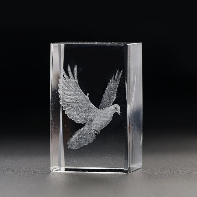 Crystal cube featuring a delicately engraved dove within. 