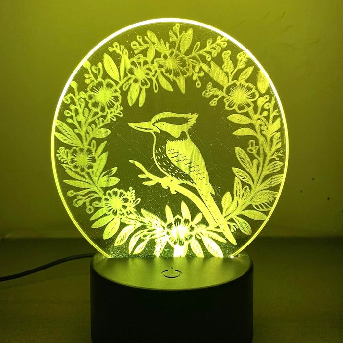 A transparent acrylic lamp engraved with bird and floral motif by Sculpfun UV laser