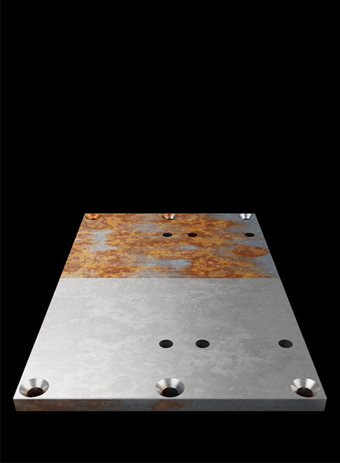 A metal plate on a black background, with one half left rusted and the other half cleaned by the Sculpfun A9 Ultra fiber laser.